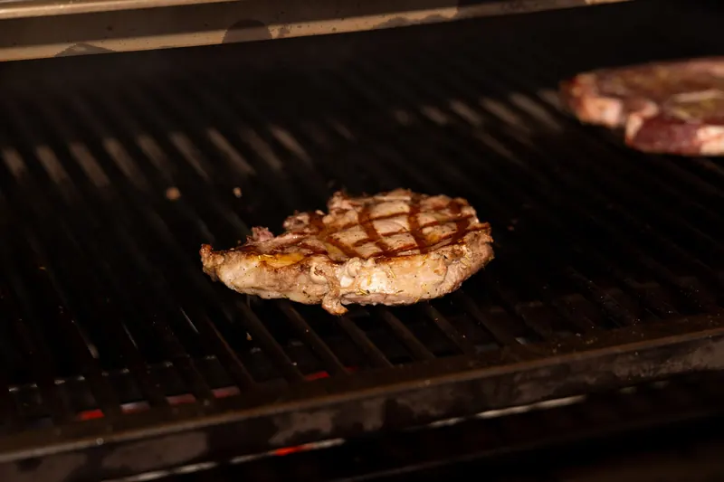 A succulent steak being grilled on a barbecue. Perfect for summertime cooking and outdoor gatherings