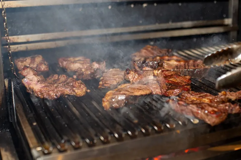 Mouthwatering steaks grilling over an open flame, showcasing sizzling and smoky barbecue goodness